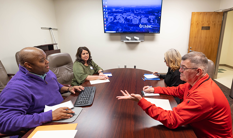 From left, Dr. Derek Holt, assistant professor of nursing and director of the family nurse practitioner track, Dr. Kim Douglas, associate professor of nursing and director of the nurse educator track, Dr. Jeanne Calcote, assistant professor of nursing and director of the nursing and health care administrator tracks, and Dr. Carl Mangum, associate professor of nursing and director of the psychiatric/mental health nurse practitioner tracks, discuss the online MSN program at UMMC.